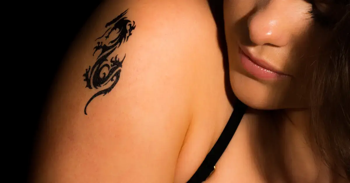 20+ Yin Yang Dragon Tattoo You Will Adore 2024 1 Yin Yang Dragon Tattoo: a woman has a Yin Yang Dragon Tattoo on her shoulder