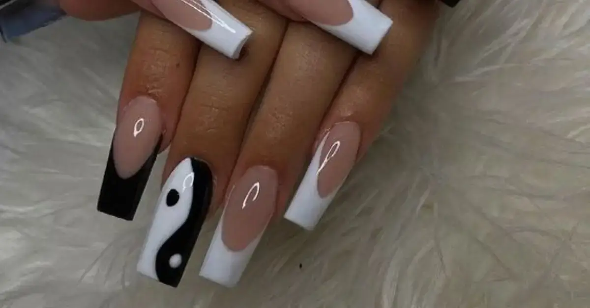 30+ Ying Yang Nails: The Hottest Trend For 2024 1 Ying Yang Nails: A woman shows her ying yang nails.