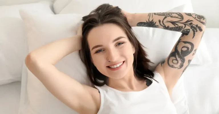 30+ Awakening Tattoo Ideas TikTok is Obsessed With 2025 45 Awakening Tattoo: a woman lie in the bed and shows her tattoo on her arm