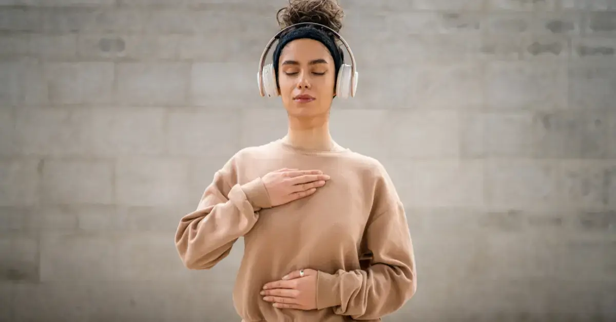 Guided Meditation: Your Path to Peaceful Relaxation 2024 1 guided meditation: a woman is sitting, had earphones and is mediating