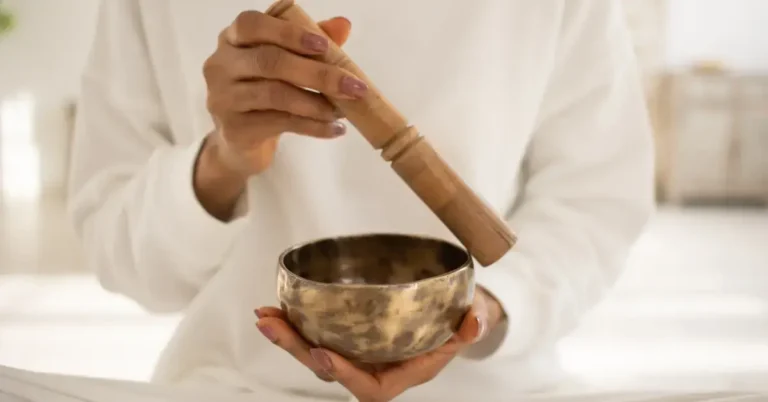 Healing Meditation Techniques for Stress Relief 2024 6 Healing Meditation: A person holds a singing bowl in his hand for a meditation