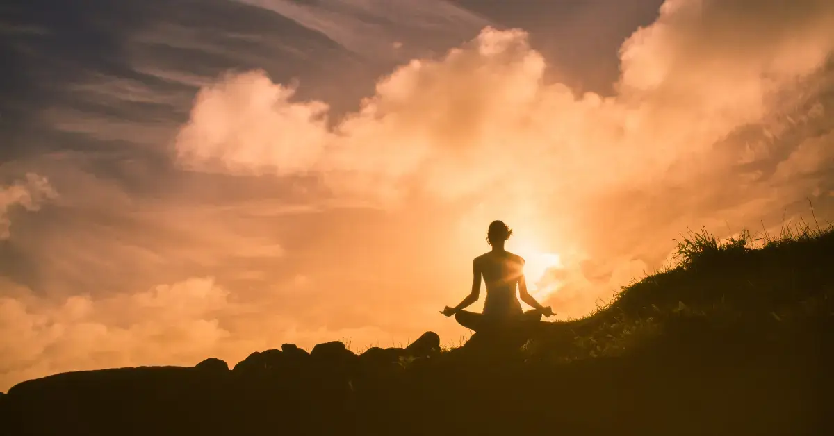 Meditation Wallpaper: a woman is mediating on a hill