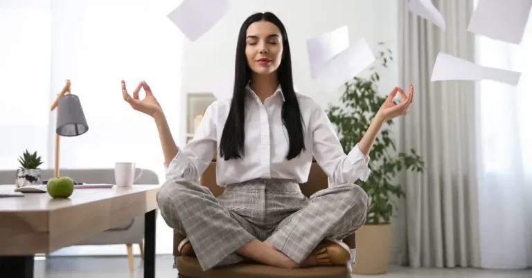 Meditation For Stress Relief At Work: For A Calmer Day 2024 2 Meditation for Stress Relief at Work: a woman is sitting in the office and meditate on her chair.