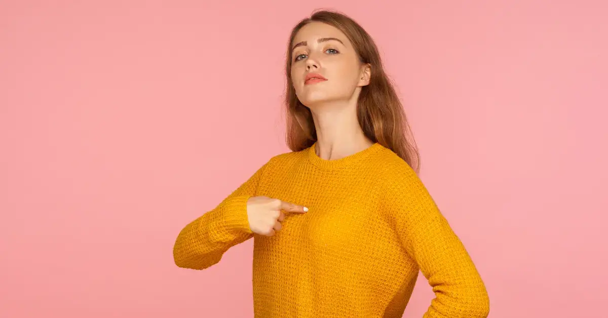 Ego vs Higher Self: a woman shows with her fingers on herself