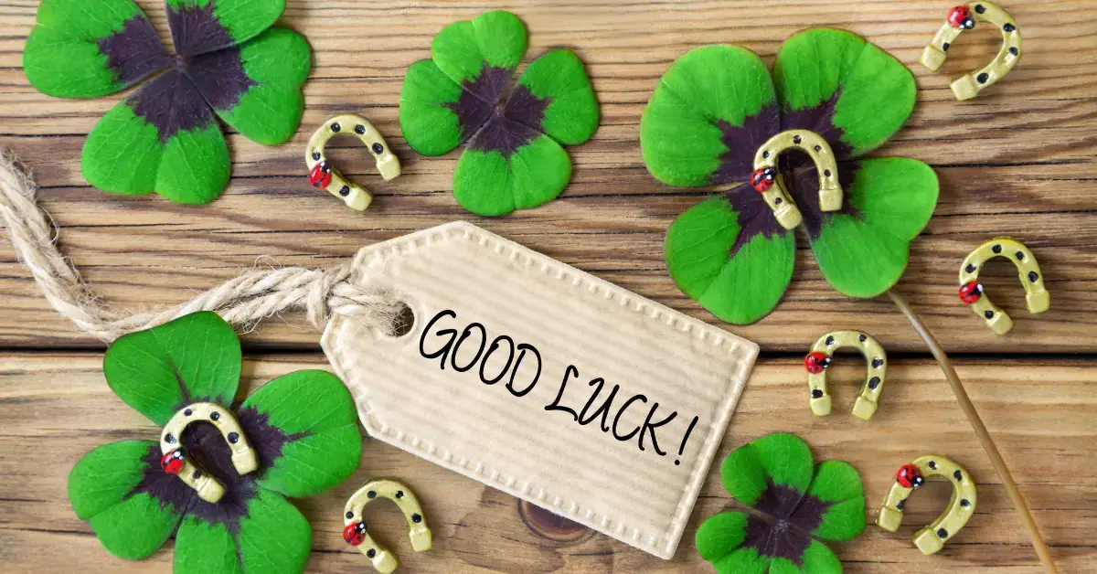 How To Attract Good Luck Spiritually: many clover leaves and a sign with "good luck"