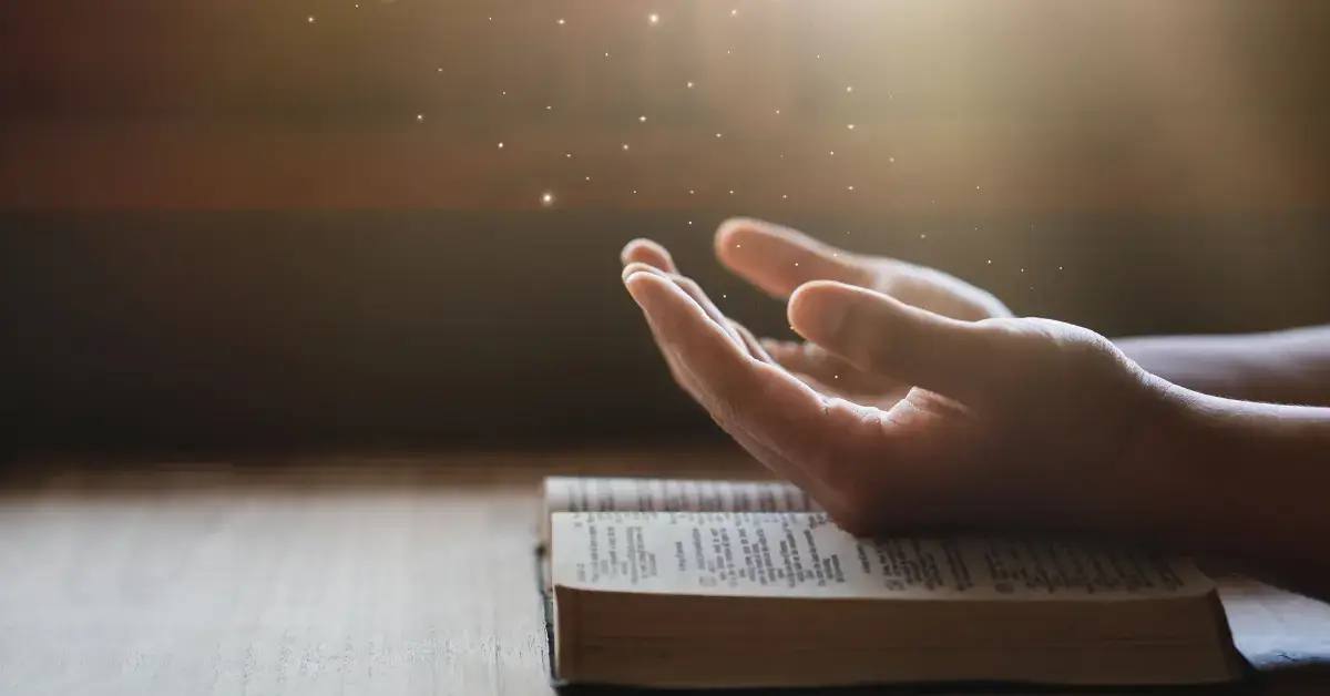 How To Be Spiritual Without Religion: A serene forest with sunlight filtering through the trees, a flowing stream, and a lone figure meditating in the midst of nature